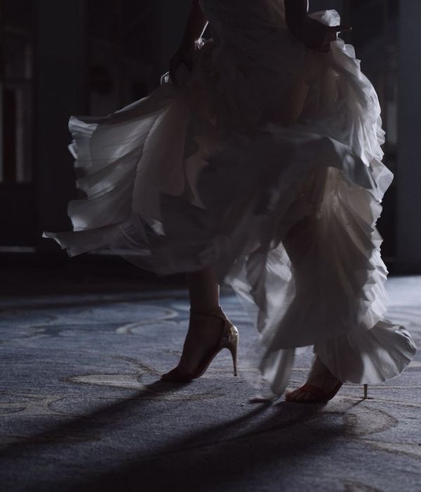 A person stretching gracefully in a bright, airy room.